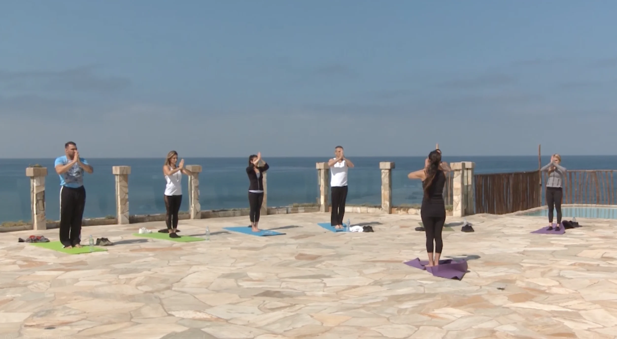 Beachfront yoga session at sunrise at the Holistic Sanctuary oceanfront healing center